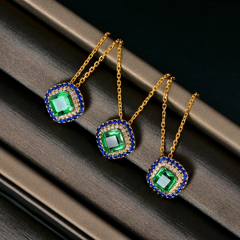 14kt Yellow Gold Emerald Pendant with Diamonds and Sapphire Accents for Women