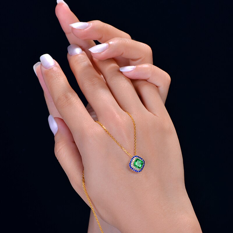 14kt Yellow Gold Emerald Pendant with Diamonds and Sapphire Accents for Women