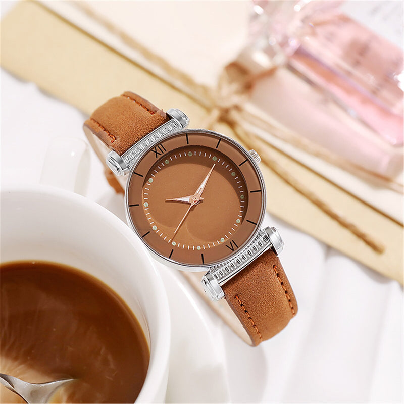 Stainless steel quartz watch with leather strap for women.
